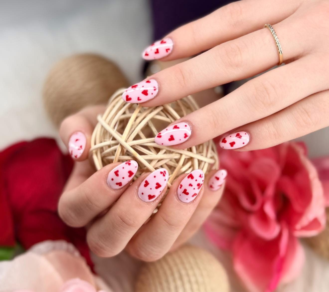 Pink manicure with red heart details